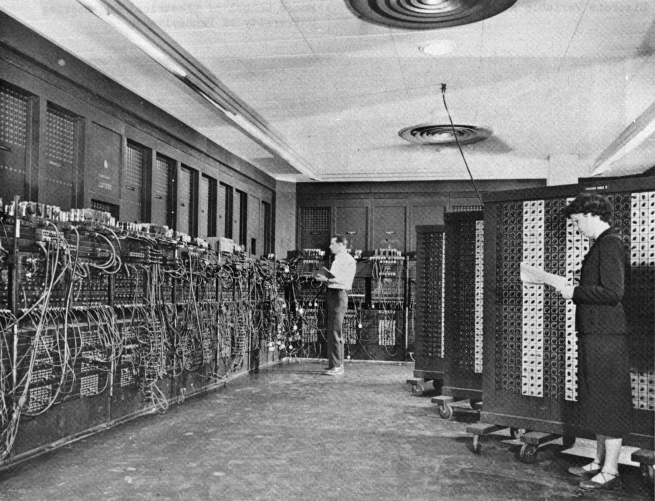 Glen Beck (background) and Betty Snyder (foreground) program ENIAC in BRL building 328. (U.S. Army photo)