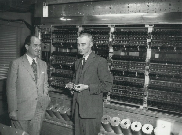 John von Neumann and Robert Oppenheimer standing in front of ENIAC (Electronic Numerical Integrator and Computer)